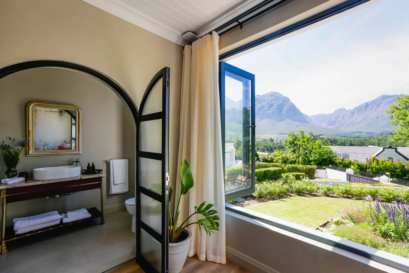 A Manor House suite with large windows framing the mountains